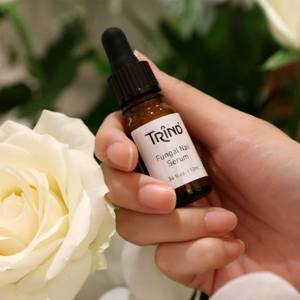 A serum on a 10 ML dropper bottle held by a women that penetrates the nail and helps to prevent the spread of the fungus within the nail and to other nails. It contains hydrolyzed keratin which restores, rebuilds and strengthens the structure of the renewed or non-affected nail.